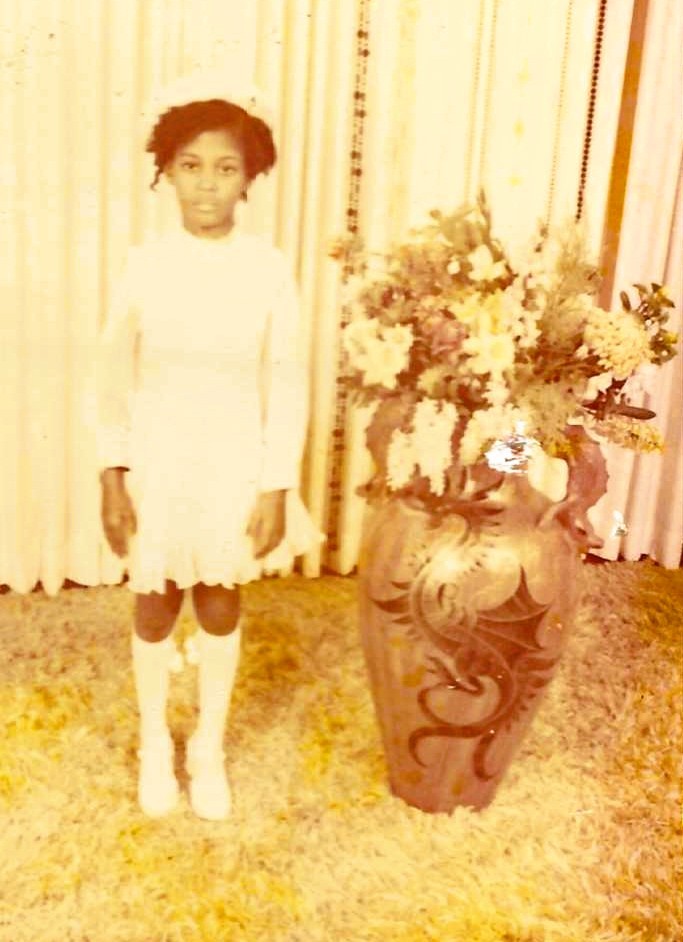 Beatrice Louissaint as a young girl in Miami, dressed for a special occasion